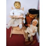 Three mid-20th century dolls, together with a dolls high chair