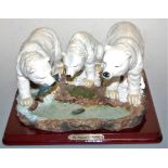 A resin model of three polar bears by the Juliana Collection upon plinth