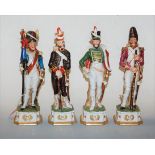 A set of four continental porcelain figures of soldiers each in standing pose on shaped square