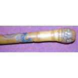 An early 20th century bamboo walking stick, carved with sinuous snakes