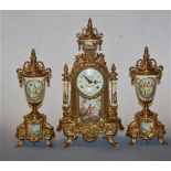 A German gilt metal cased and porcelain inset three piece mantel clock garniture having an enamel