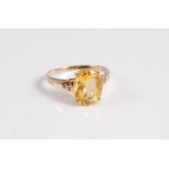 A 9ct oval citrine ring set with small white hardstones, with plain band with Common Control mark,
