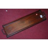 An Edwardian mahogany drinks tray of rectangular form having twin brass handles, width 72cm