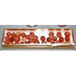 A collection of hand-carved melon shaped pema raka carnelian beads, from China/Tibet