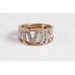 A 9ct and diamond ring, the tapered half hoop ring set with Roman numerals with diamond