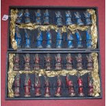 A boxed set of modern Chinese resin figural chess pieces