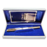 A Christian Dior silver gilt cased fountain pen, No.ABF458, having 14ct gold nib, boxed with