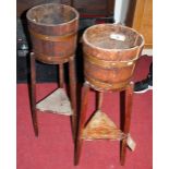 A pair of early 20th century oak and brass bound circular planters, each with triangular platform