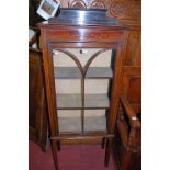 An Edwardian stained walnut ledgeback single door glazed china display cabinet, width 59cm