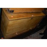 A Victorian stained pine hinge top mule chest with iron end carry handles, having twin lower