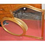 A contemporary gilt wood arched top bevelled frame wall mirror, together with one other similar oval