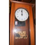 A mid-20th century electric droptrunk wall clock, with white enamel circular dial and pendulum, h.