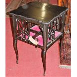 An Edwardian ebonised four division shaped top book table, width 51cm