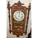 A late Victorian walnut and Tunbridge type inlaid drop trunk wall clock, having ring turned outer