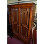 A contemporary yew wood double door glazed bookcase, having twin short lower drawers, width 101.5cm