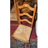 A set of six modern pine ladderback and rush seat dining chairs