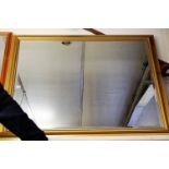 A reproduction gilt framed and bevelled rectangular wall mirror, of good size, 106 x 137cm; together