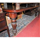 A mid Victorian mahogany round cornered extending dining table having a wind-out action, two extra