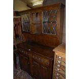 A contemporary moulded oak and lead glazed linenfold panelled dresser, width 114.5cm