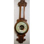 An early 20th century relief carved oak aneroid two dial wheel barometer by A Wehrle & Sons,