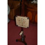 An early Victorian rosewood and floral needlework tapestry inset pole screen