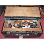 A portable black painted tool box, with hinged cover and sundry contents