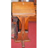 A late Victorian oak freestanding lectern, with relief carved panel in the ecclesiastical taste