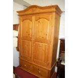 A modern pine double door wardrobe having single long lower drawer, width 131cm