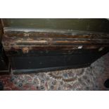 An early 20th century stained pine and metal bound hinge top military travelling trunk, having