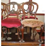 A set of five Victorian mahogany balloon back salon chairs, each having floral upholstered and