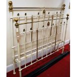 A Victorian white painted cast iron and brass kingsize bedstead, having painted iron side rails