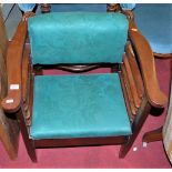 An early 20th century walnut and green floral upholstered elbow chair by Utico having laddered