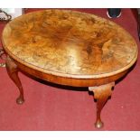 A 1920s figured walnut oval low occasional table, w.70cm