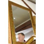 A reproduction gilt framed and bevelled wall mirror, 107 x 76cm