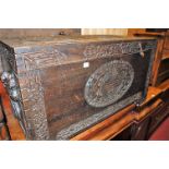 A circa 1900 Chinese camphorwood hinge top blanket box, having all over relief carved detail, the