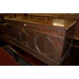 An 18th century geometric moulded oak three panelled hinge top coffer (with losses to mouldings),