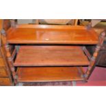 A mid-Victorian mahogany thee-tier whatnot, raised on turned supports (central platform