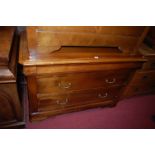 A contemporary cherry wood chest having a blind frieze drawer over two long lower drawers, width