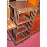 An Edwardian mahogany serpentine shaped top revolving bookcase, w.51cm