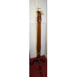 A late Victorian mahogany standard lamp, having a reeded column to hipped supports (converted),