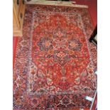 A Persian style red ground woollen Tabriz rug, 197x141cm