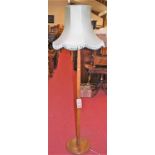 An early 20th century turned beech standard lamp