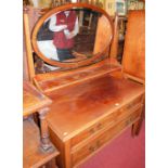 An early 20th century mahogany oval bevelled swing mirrorback dressing chest, having two short