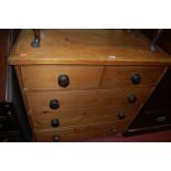 A Victorian pine chest of two short over three long drawers, having ebonised turned handles, width