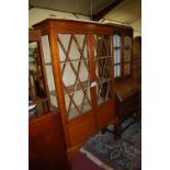 An Edwardian mahogany and chequer strung bowfront double door glazed china display cabinet, having