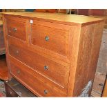 A contemporary oak effect chest of two short over two long drawers, width 91cm