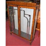 An Art Deco figured walnut double door glazed china display cabinet on squat cabriole supports,