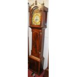 An early 19th century flame mahogany and mahogany crossbanded long case clock, having a painted arch