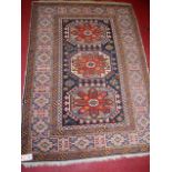 A caucasian woollen rug, having a geometric floral central ground within trailing tramline