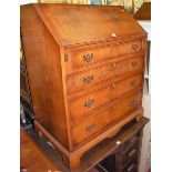 A reproduction yew wood slopefront four drawer writing bureau, width 79cm